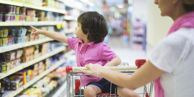 Small boy with his mother in a super market