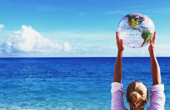 Woman holding globe beach ball