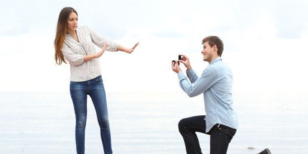 Proposal rejection when a happy man asks in marriage to a woman on the beach