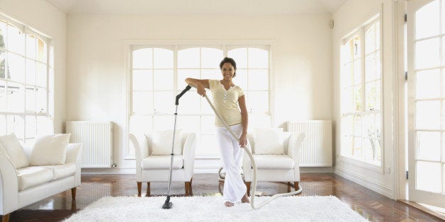 Hispanic woman vacuuming floor