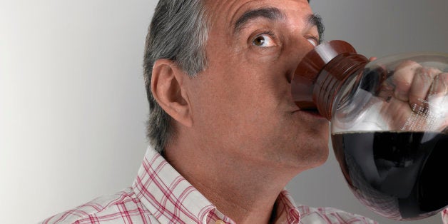 Senior man drinking coffee from pot