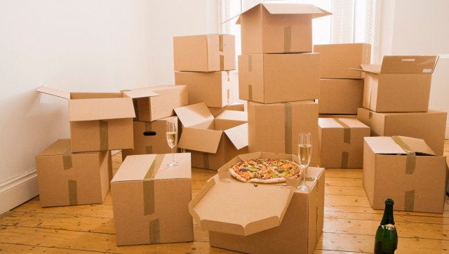 Pizza and champagne on moving boxes