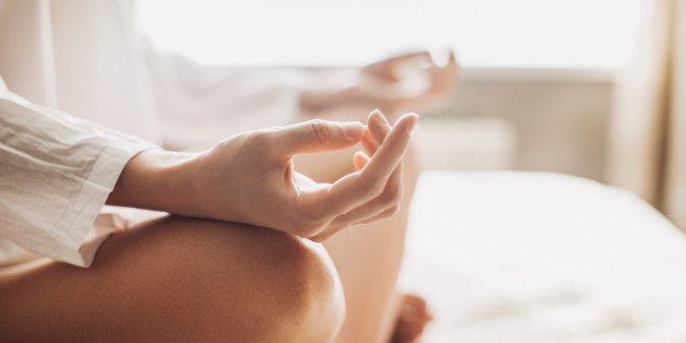 Hands of young beautiful woman practicing yoga indoors