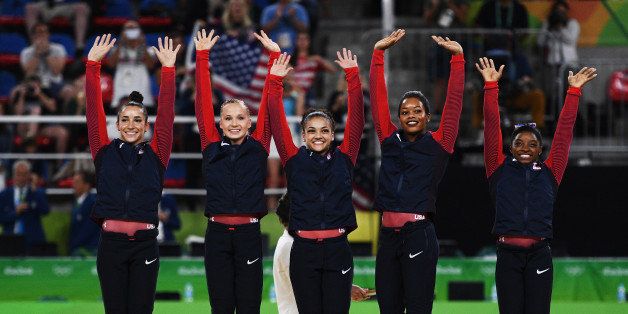 RIO DE JANEIRO, BRAZIL - AUGUST 09: (R to L) Gold Medalists Simone Biles, Gabrielle Douglas, Lauren Hernandez, Madison Kocian and Alexandra Raisman of the United States celebrate on the podium at the medal ceremony for the Artistic Gymnastics Women's Team Final on Day 4 of the Rio 2016 Olympic Games at the Rio Olympic Arena on August 9, 2016 in Rio de Janeiro, Brazil. (Photo by David Ramos/Getty Images)