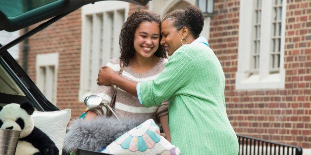 Mother and daughter hugging near car