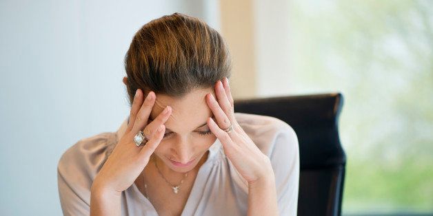 Close-up of a businesswoman suffering from a headache in an office