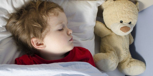 Little boy sleeping in his bed