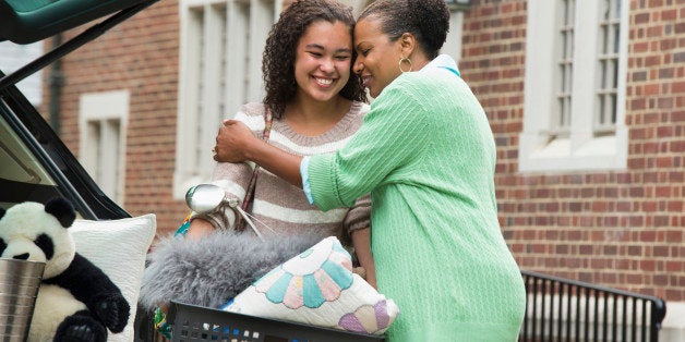 Mother and daughter hugging near car