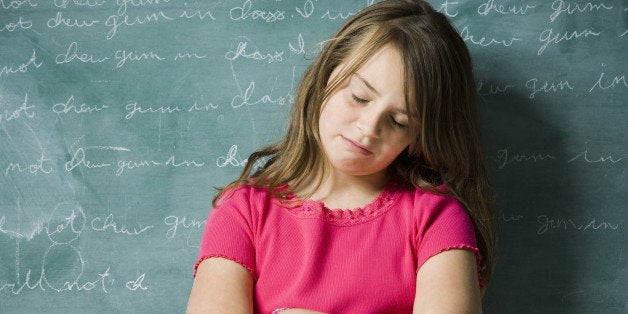 A young girl being punished at school