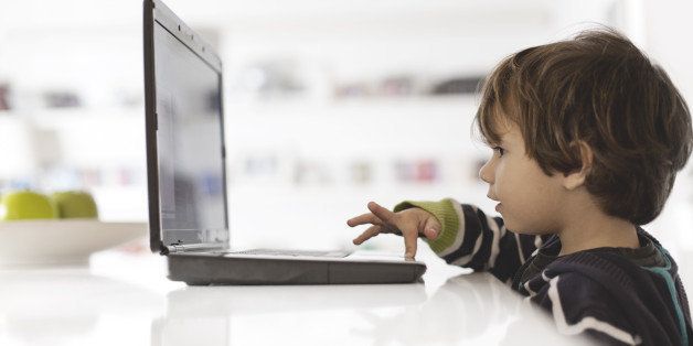 Small boy using a laptop