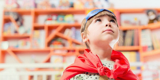 indoors, bookshop, library, play, props, portrait, kid, standing, messy, colourful, gender blending, dressing up, fun, mask, super hero, cape, knot, looking up, serious, daydreaming,