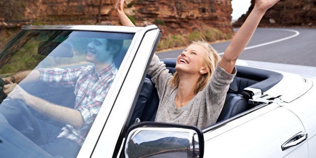 Shot of a happy couple enjoying a road trip