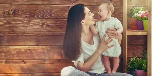 Happy loving family. Mother and her child baby girl playing in the summer day.