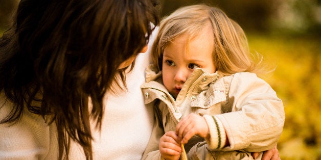 Mother regreting her sad little child - outdoor in nature