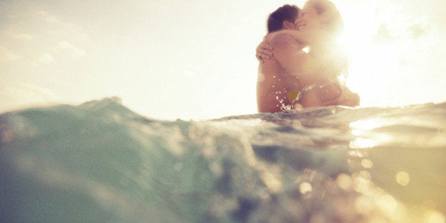 young couple having fun in the sea