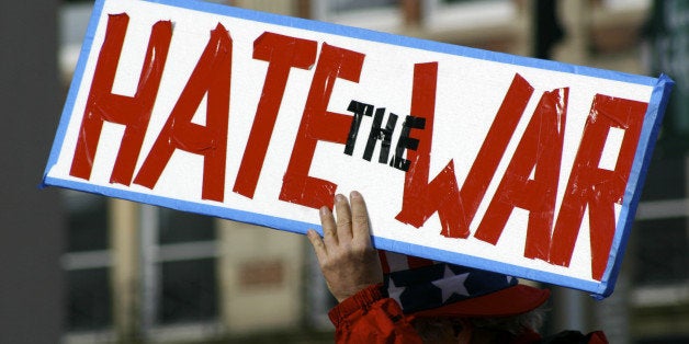 Iraq war political protester holding a sign that says 'hate the war'See other protest related photos including more from this series: