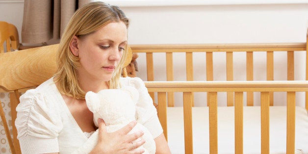 Sad Mother Sitting In Empty Nursery