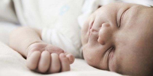 Portrait of sleeping male newborn, close-up