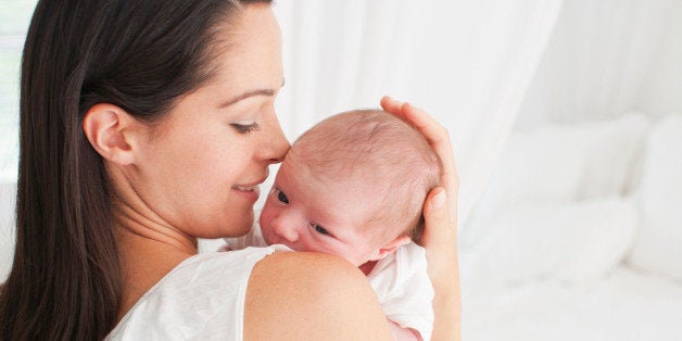 Smiling mother holding baby