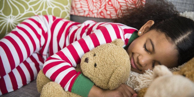 Mixed race girl sleeping on sofa