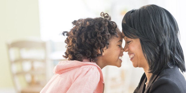 Black mother and daughter rubbing noses