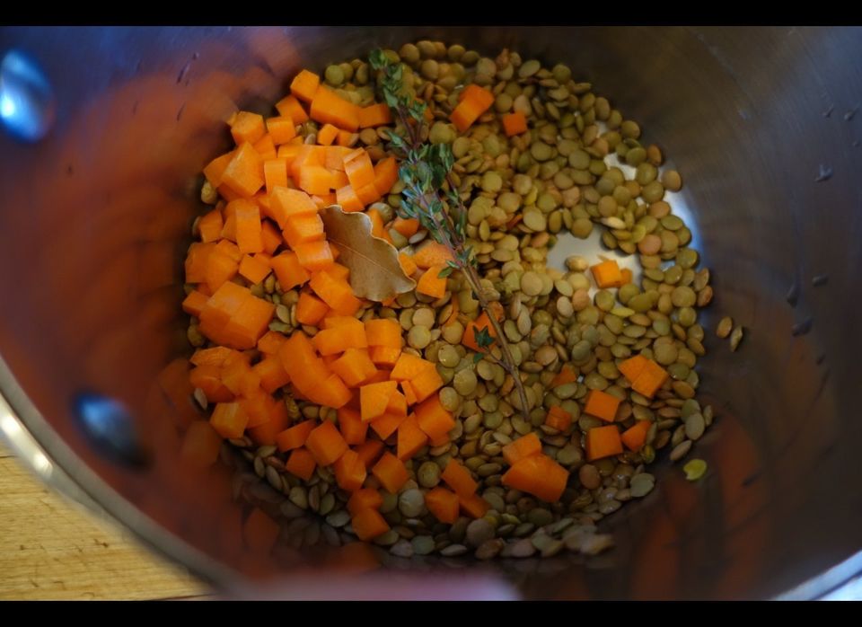 Brown lentils and aromatics, ready to be simmered
