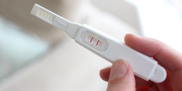 Woman holding a pregnancy test device