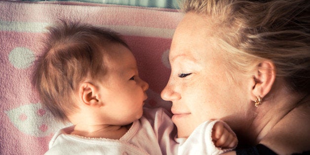 Mother with newborn baby sleeping, symbolizing love and child care