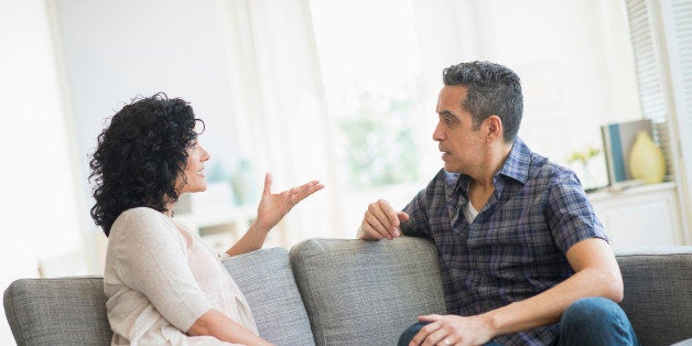 USA, New Jersey, Jersey City, Couple talking on sofa