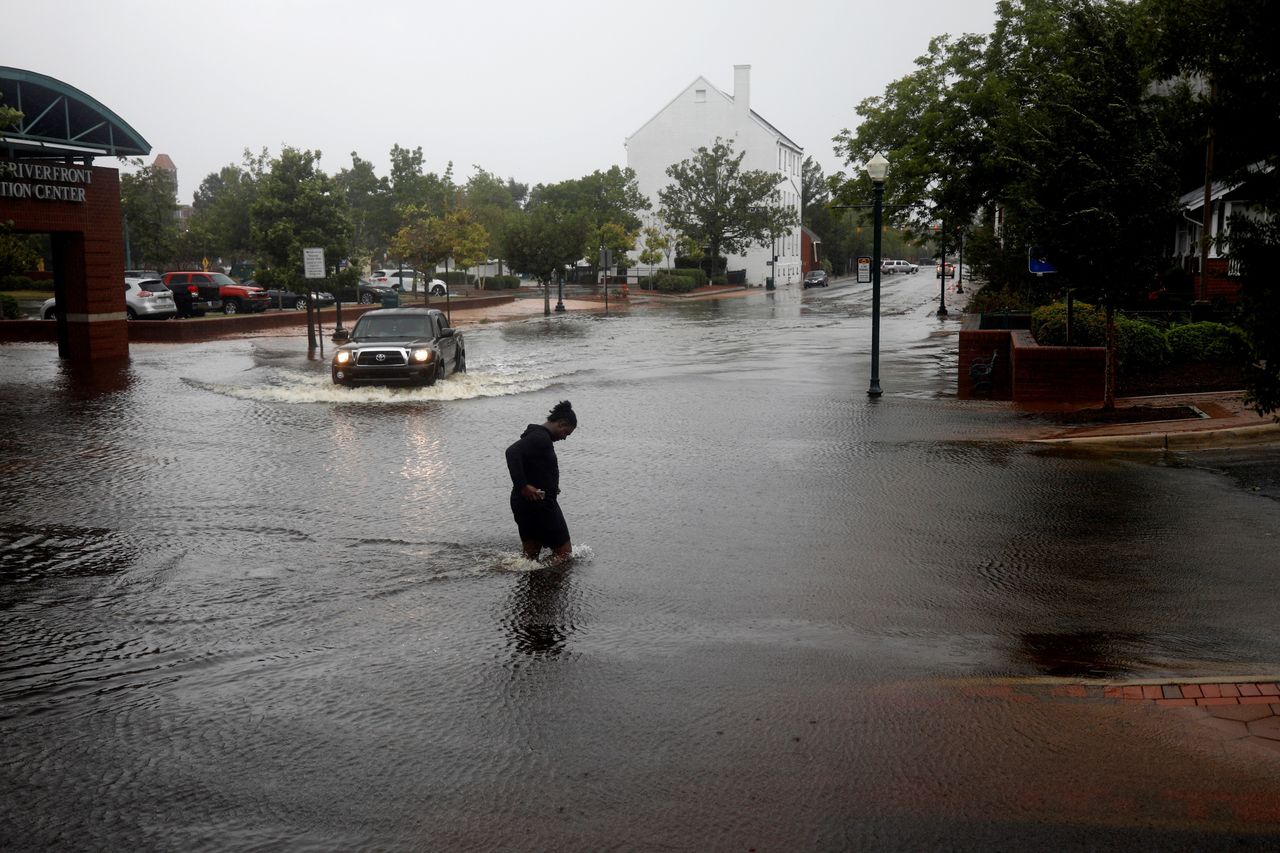 A man tries to cross the street during the heavy rain of outer bands of Hurricane Florence in New Bern, North Carolina.