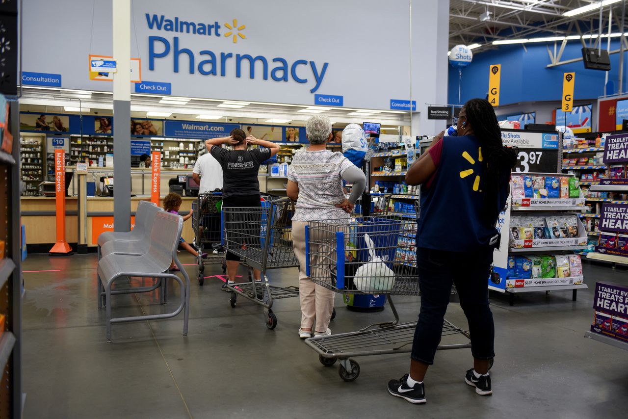 <strong>Shoppers wait in line to be served at the pharmacy of a Walmart Inc. store ahead of Hurricane Florence in Charlotte, North Carolina.</strong>