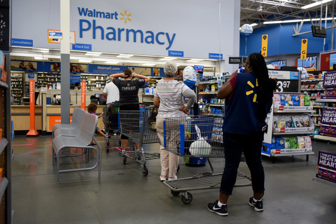 Shoppers wait in line to be served at the pharmacy of a Walmart Inc. store ahead of Hurricane Florence in Charlotte, North Carolina.