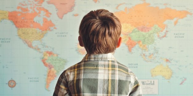 Little boy looking at world map