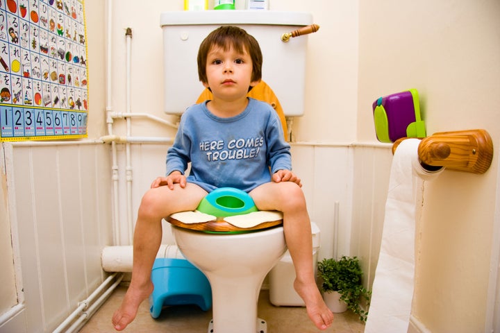 Potty Training. Little cute child girl sitting on a toilet. Stock Photo