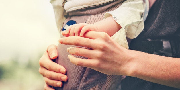 Baby and mother holding hands embracing happy Family parents love concept