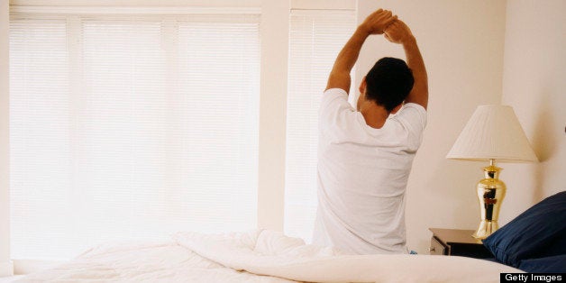 Man on Bed Stretching