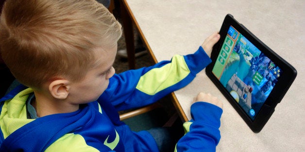 Preteen Boy Using iPad to Learn Coding for School Assignment, Wellsville, New York. (Photo by: Education Images/UIG via Getty Images)