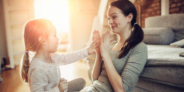 Close up of a mother and daughter having fun at home