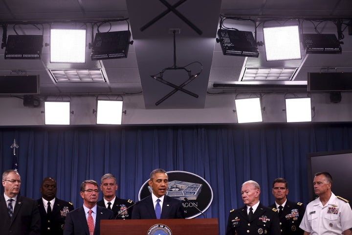 President Barack Obama briefs reporters on U.S. efforts against the self-described Islamic State. Obama expanded the 2001 authorization to apply to the U.S. battle against ISIS.