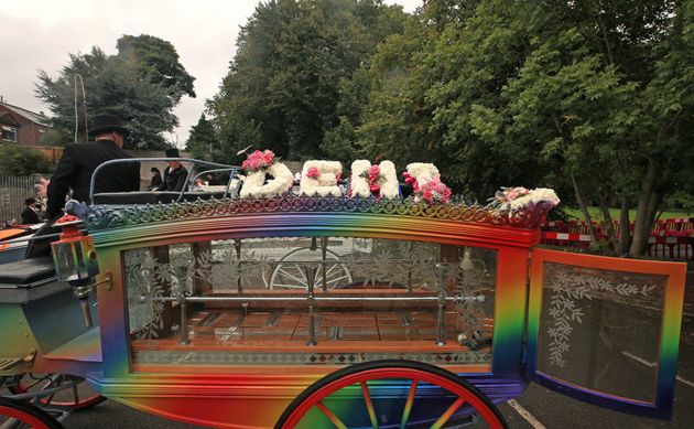 A horse drawn carriage carrying the coffin of Demi Pearson