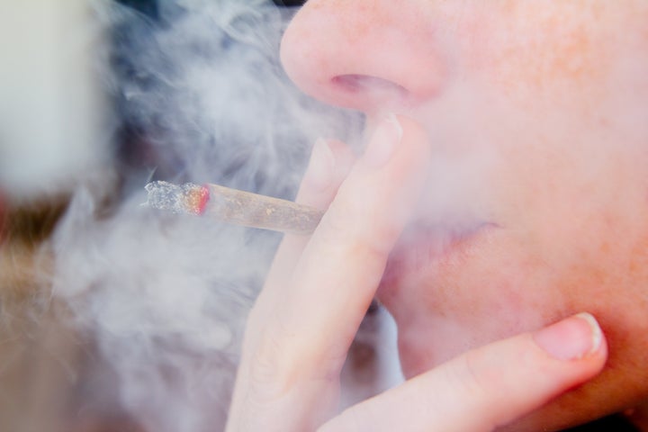 smoking joint closeup with smoke like unhealthy tobacco