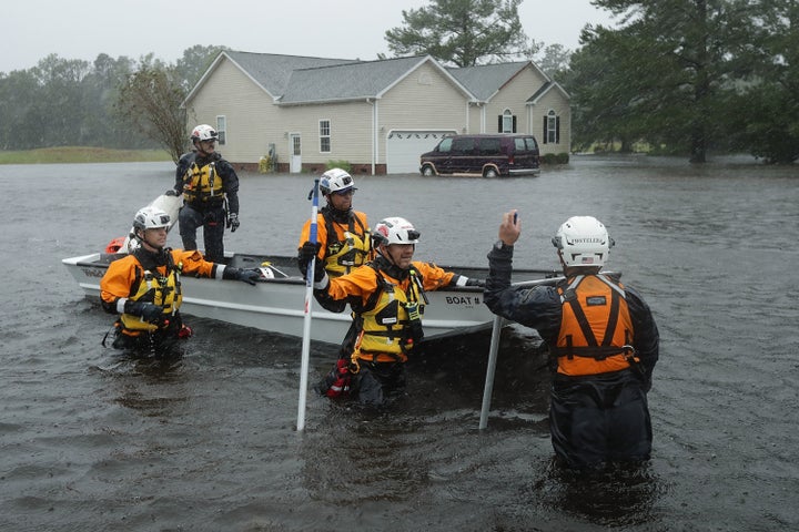 Members of the FEMA Urban Search and Rescue Task Force 4 from Oakland, California, search a flooded neighborhood for evacuees during Hurricane Florence