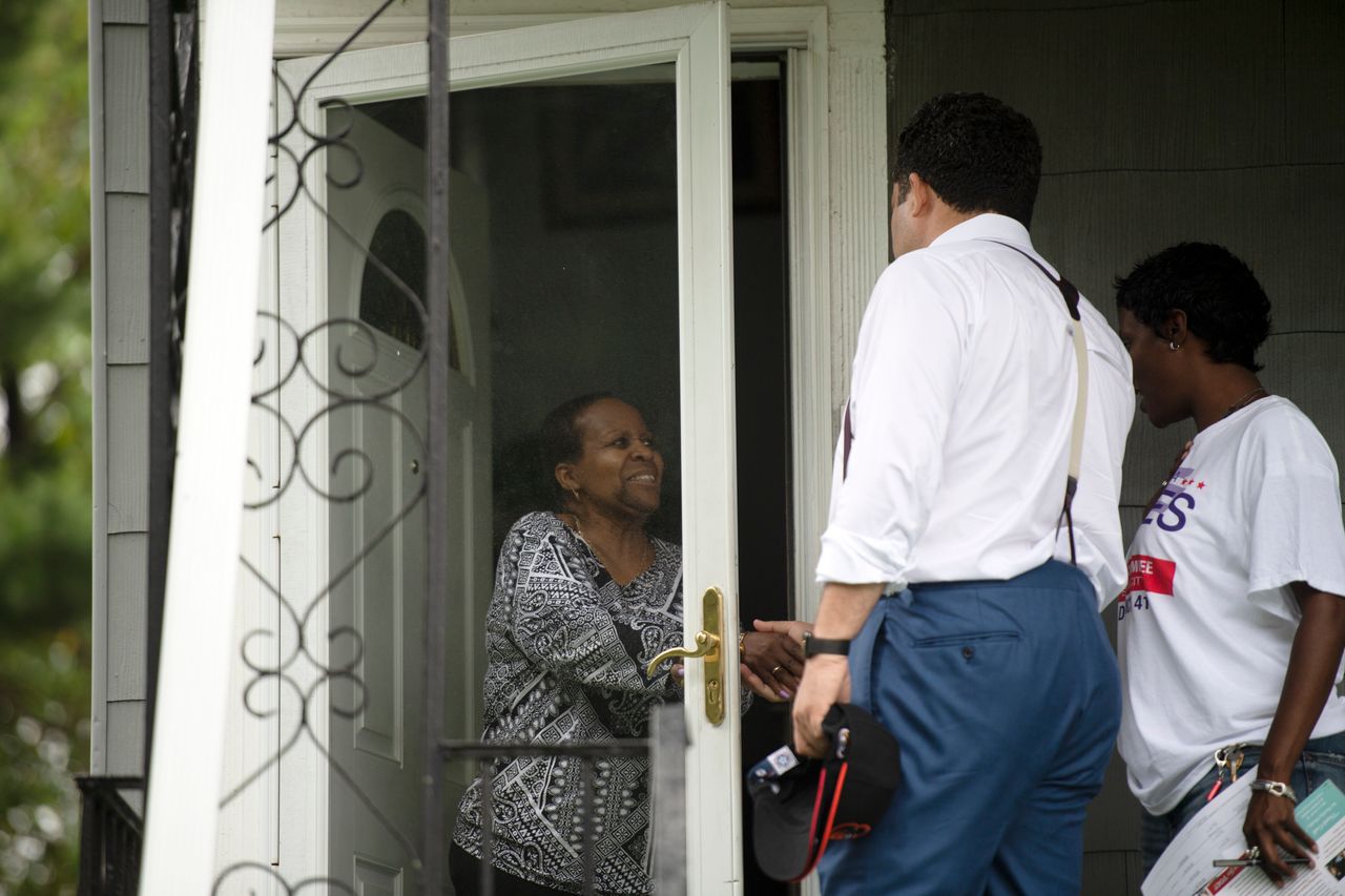 Ben Jealous chats with a voter while canvassing in Baltimore.