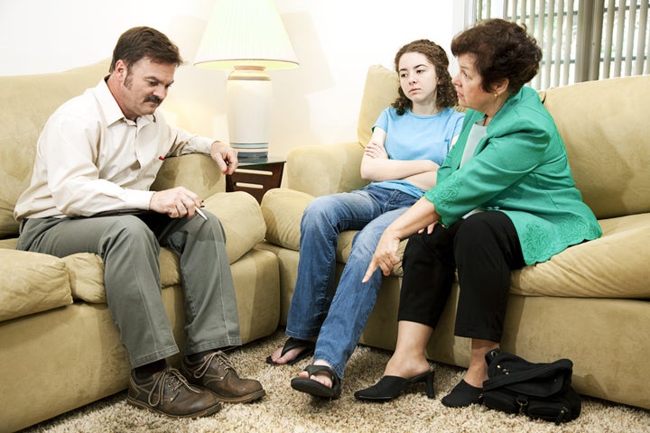 Teenage girl at the counselor's office, listening to her mother criticize her clothing choices.