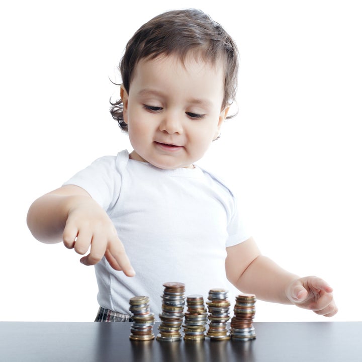 little boy plays with coins