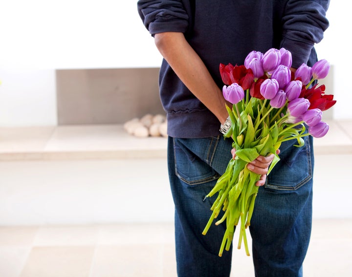 Romantic man giving flowers to his girlfriend