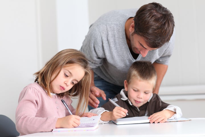 Man helping kids with homework