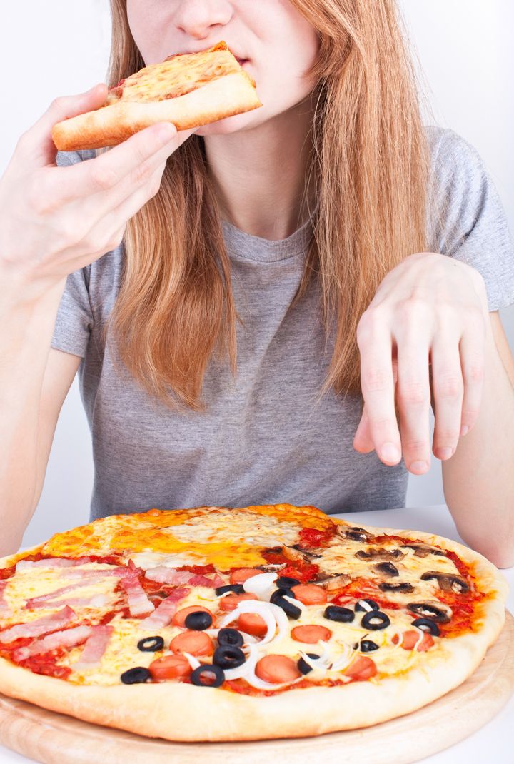 young girl eating pizza