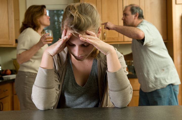 Teen daughter struggles while parents fight behind her