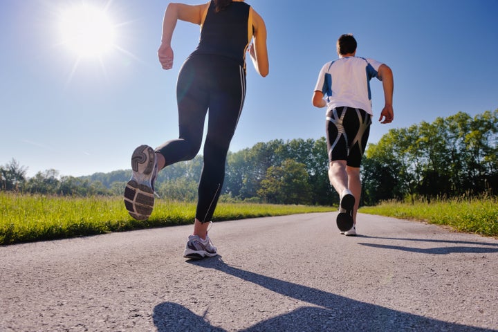 young couple jogging in park at ...